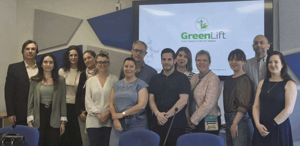 13 members of the GreenLift consortium smiling while standing up together in a group.